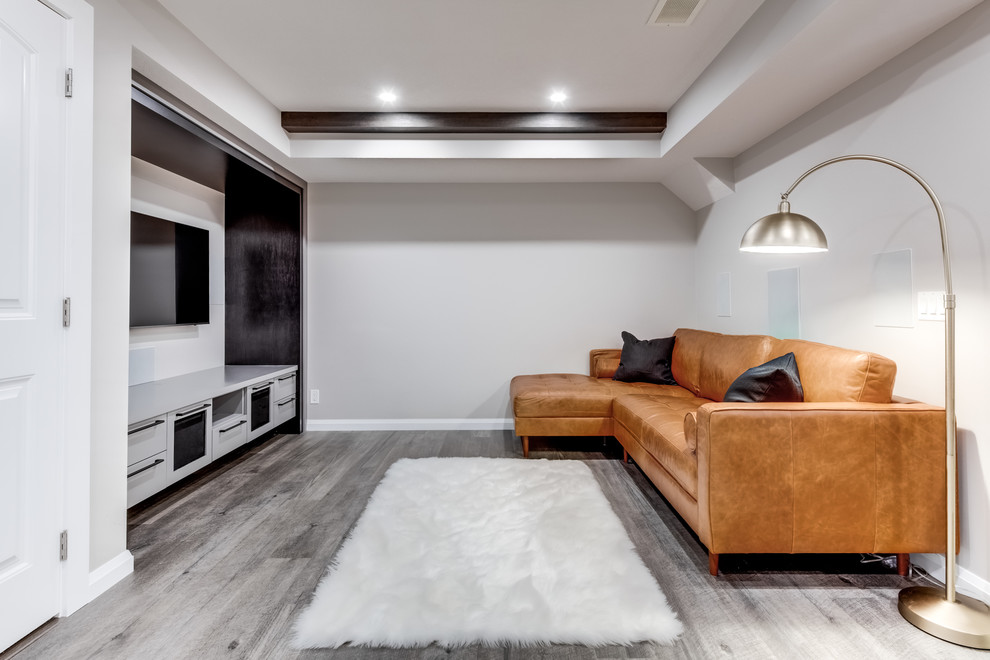 Small contemporary fully buried basement in Calgary with grey walls, vinyl floors, no fireplace and grey floor.