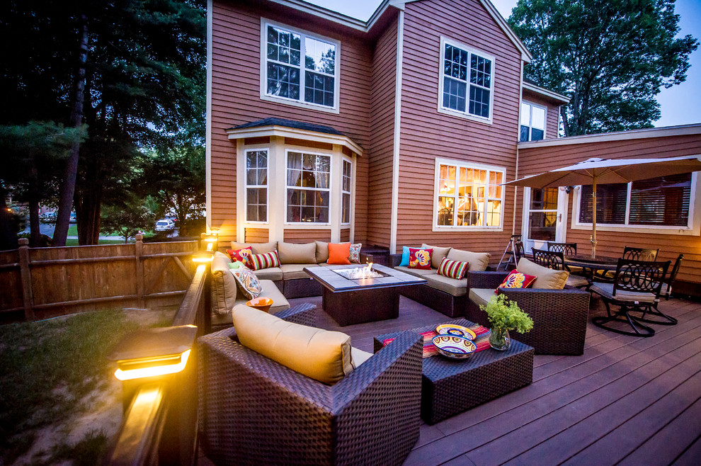 Photo of a large contemporary backyard deck in Boston with a fire feature and no cover.