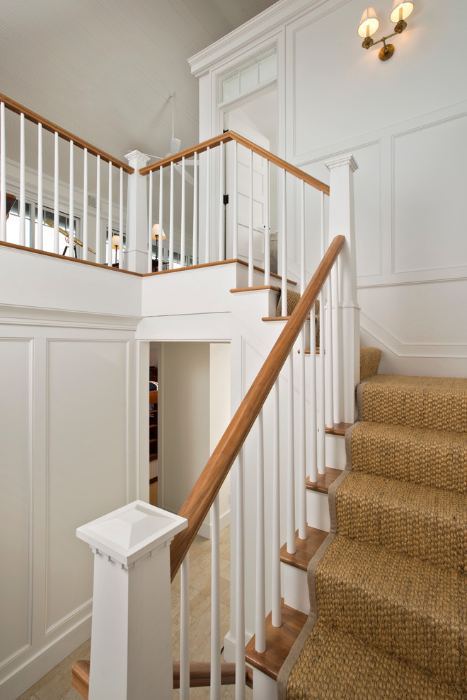 Design ideas for a large beach style wood l-shaped staircase in New York with carpet risers.