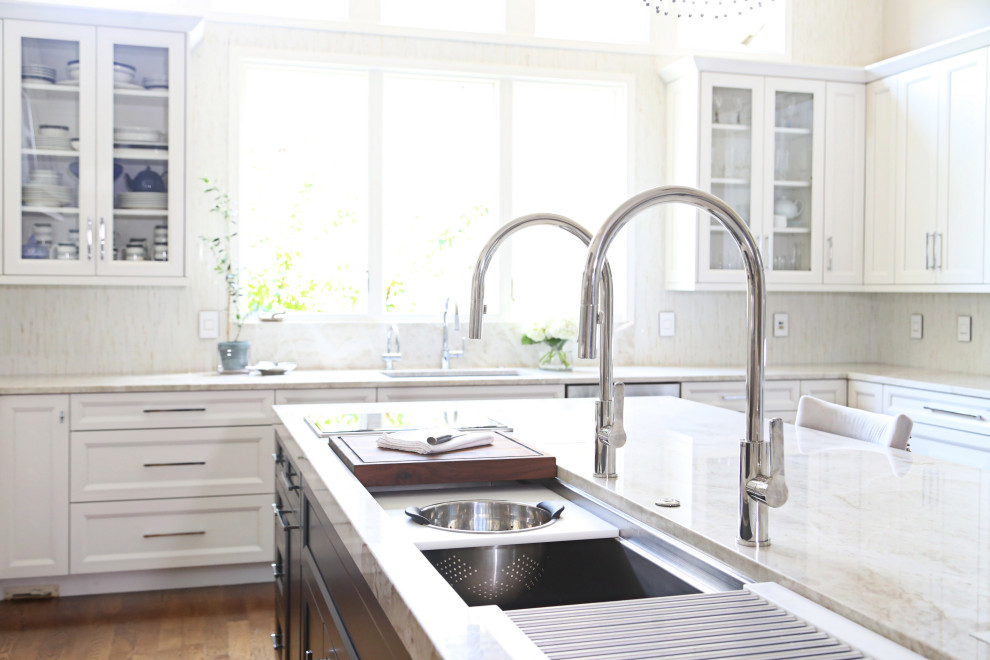 Eat-in kitchen - huge transitional medium tone wood floor and brown floor eat-in kitchen idea with an undermount sink, recessed-panel cabinets, white cabinets, quartzite countertops, white backsplash, ceramic backsplash, stainless steel appliances, an island and white countertops