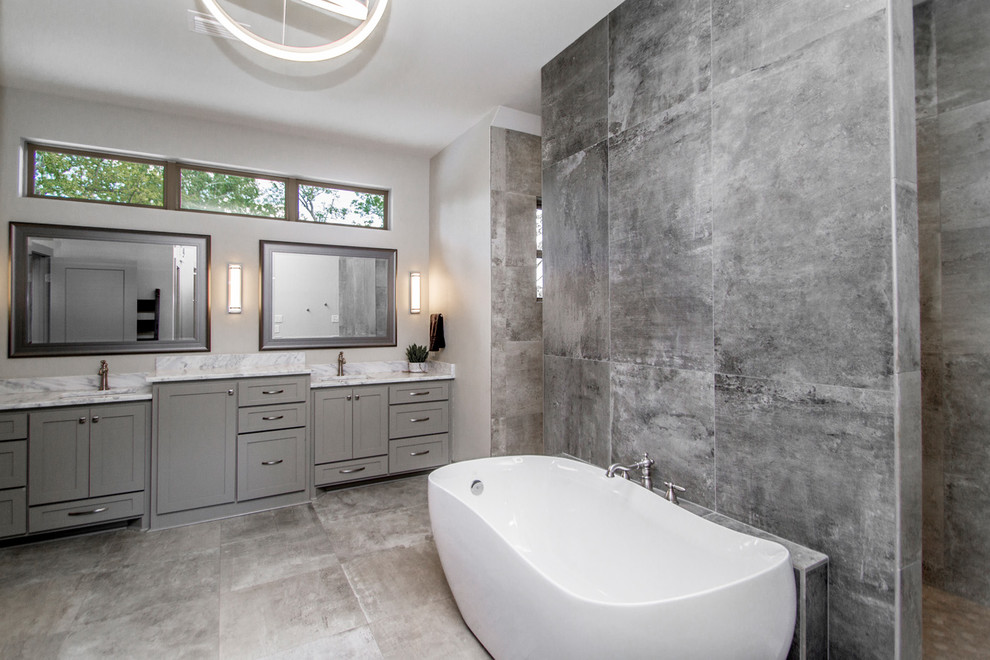 Large contemporary master bathroom in Little Rock with shaker cabinets, grey cabinets, a freestanding tub, a double shower, gray tile, grey walls, concrete floors, an undermount sink, marble benchtops, grey floor, an open shower and grey benchtops.