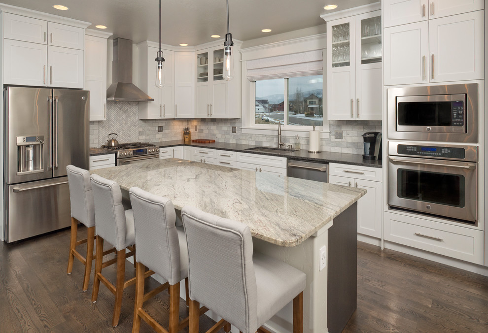 Inspiration for a transitional l-shaped kitchen in Other with an undermount sink, shaker cabinets, white cabinets, white splashback, stainless steel appliances, dark hardwood floors and with island.