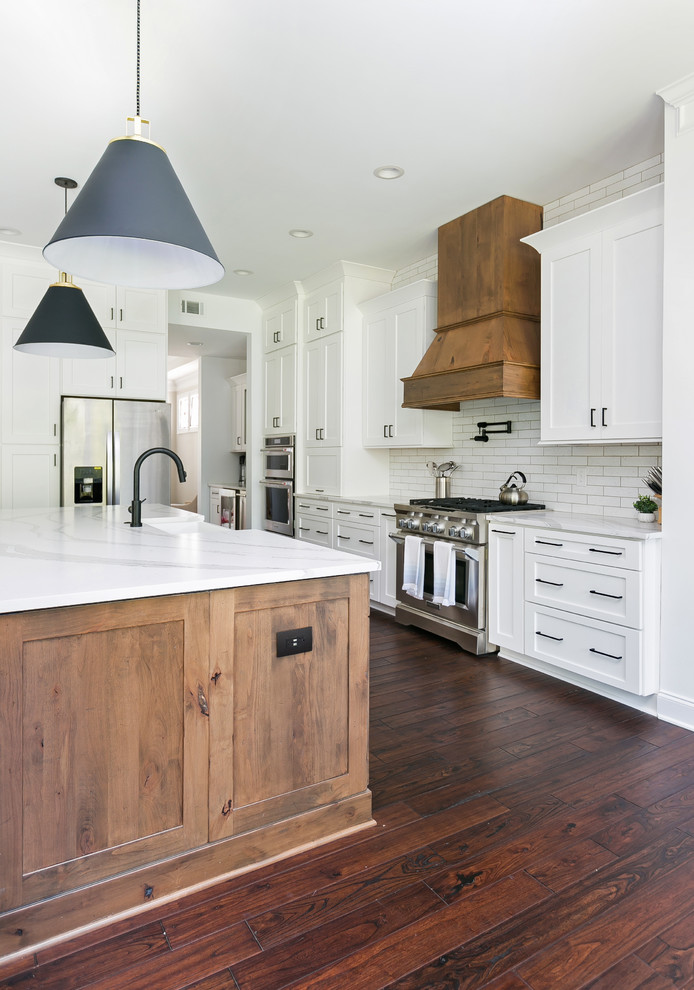 Design ideas for an expansive country open plan kitchen in Charleston with a farmhouse sink, shaker cabinets, white cabinets, quartz benchtops, white splashback, brick splashback, stainless steel appliances, with island and white benchtop.