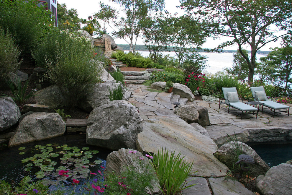 Design ideas for a beach style garden in New York with a water feature.
