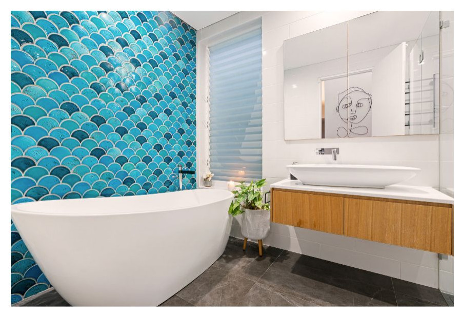 Large modern master bathroom in Sydney with light wood cabinets, a freestanding tub, blue tile, mosaic tile, white walls, slate floors, a wall-mount sink, solid surface benchtops, grey floor, white benchtops, a single vanity and a floating vanity.