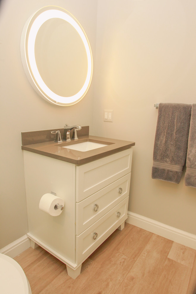 Inspiration for a mid-sized transitional 3/4 bathroom in Detroit with flat-panel cabinets, white cabinets, an alcove shower, a two-piece toilet, grey walls, porcelain floors, an undermount sink, engineered quartz benchtops, beige floor, brown benchtops, a single vanity and a built-in vanity.