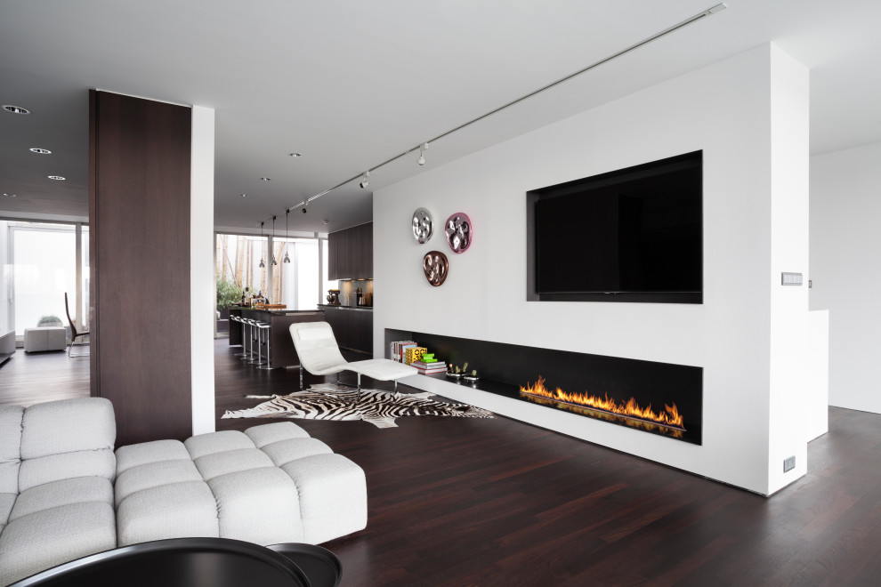 This is an example of a contemporary living room in London with a standard fireplace and a plaster fireplace surround.
