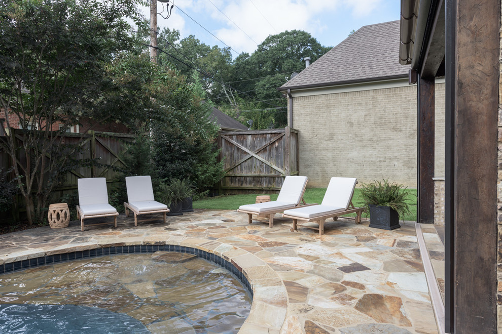 Large backyard stone and custom-shaped natural pool fountain photo
