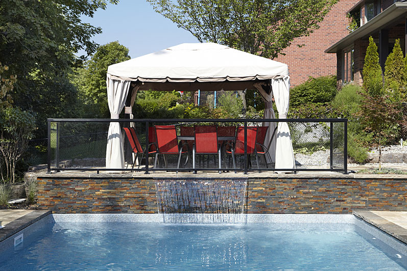 Pool fountain - large contemporary backyard stone and l-shaped natural pool fountain idea in Toronto