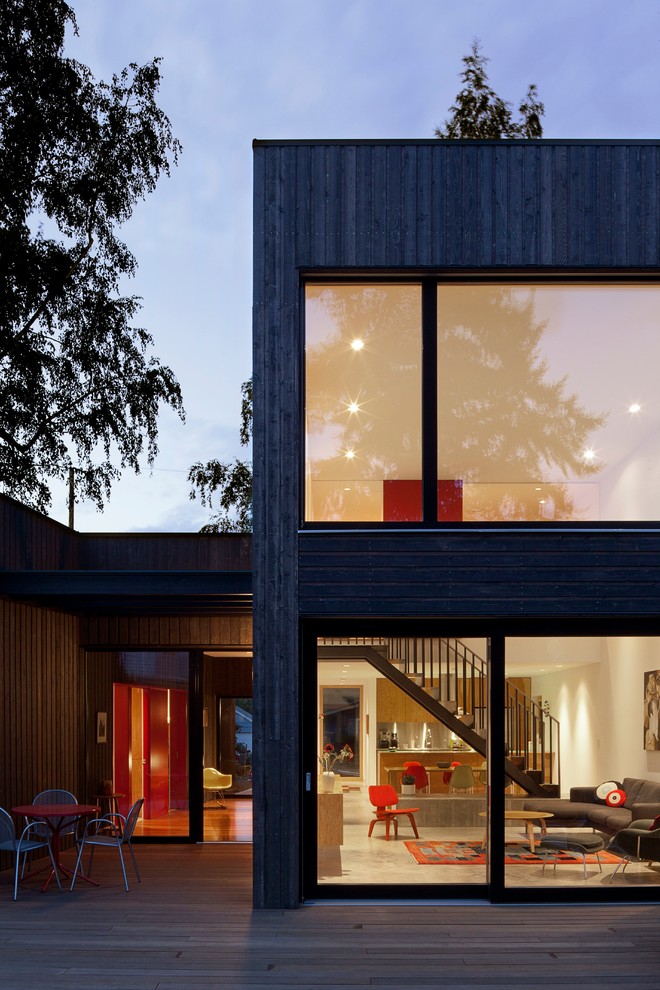 Contemporary two-storey exterior in Portland with wood siding and a flat roof.