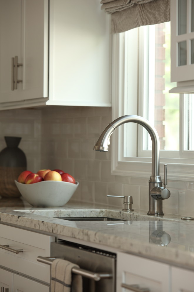 Enclosed kitchen - mid-sized transitional l-shaped light wood floor and beige floor enclosed kitchen idea with an undermount sink, shaker cabinets, gray cabinets, granite countertops, white backsplash, porcelain backsplash, stainless steel appliances and an island