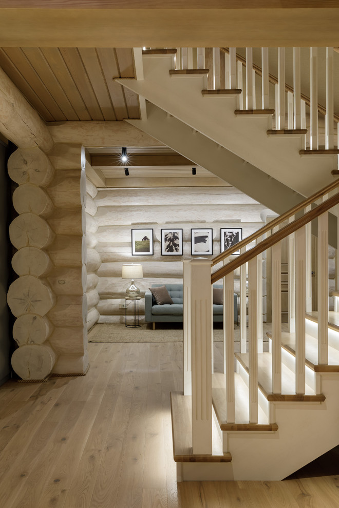 Inspiration for a mid-sized country wood u-shaped staircase in Other with wood risers, wood railing and wood walls.