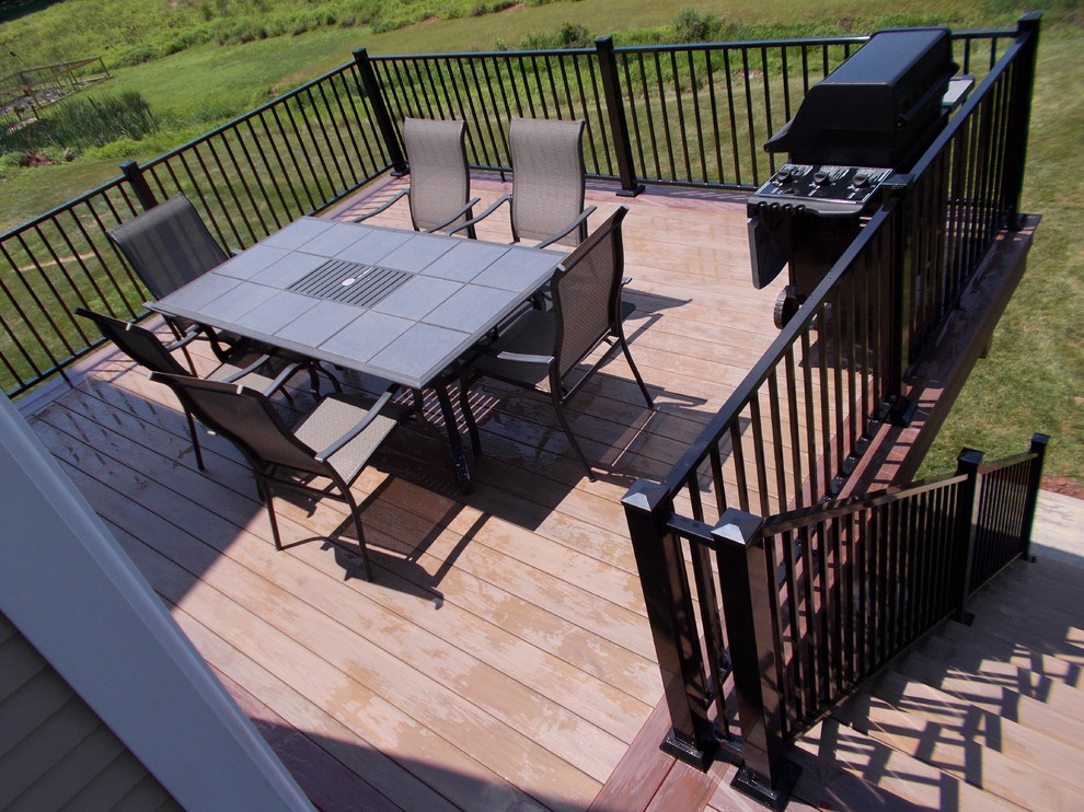 This is an example of a mid-sized traditional backyard deck in New York.