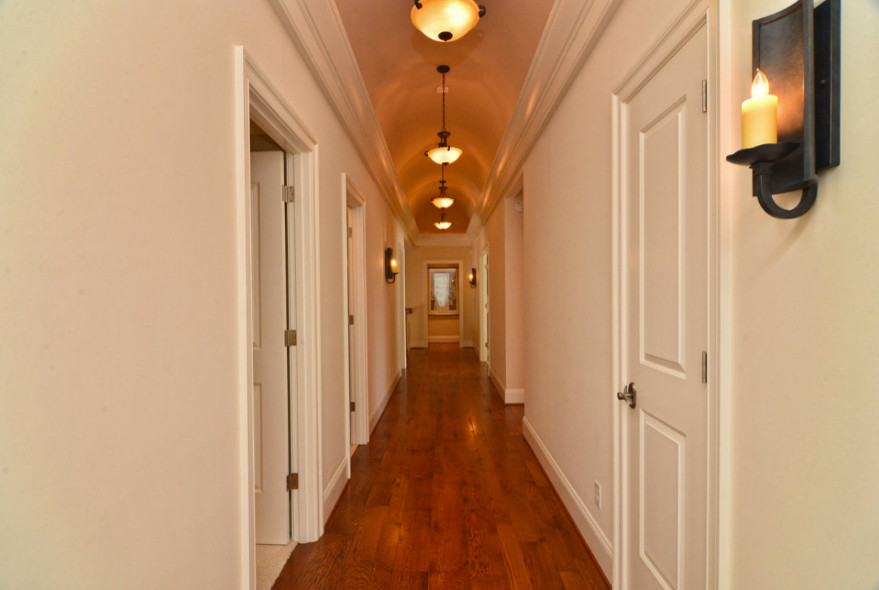 Inspiration for a medium tone wood floor hallway remodel with white walls