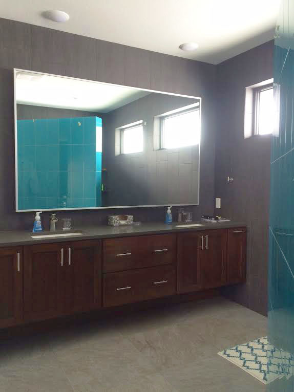 Example of a large transitional master blue tile and porcelain tile porcelain tile home design design with recessed-panel cabinets, dark wood cabinets, a two-piece toilet, gray walls, an undermount sink and granite countertops