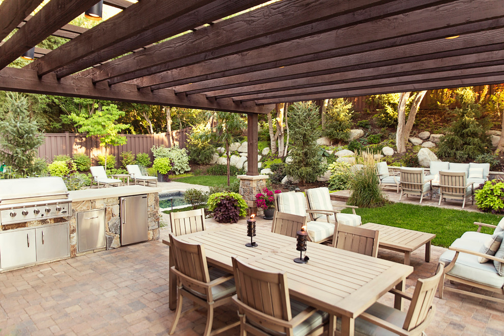 Traditional patio in Salt Lake City with concrete pavers and a pergola.