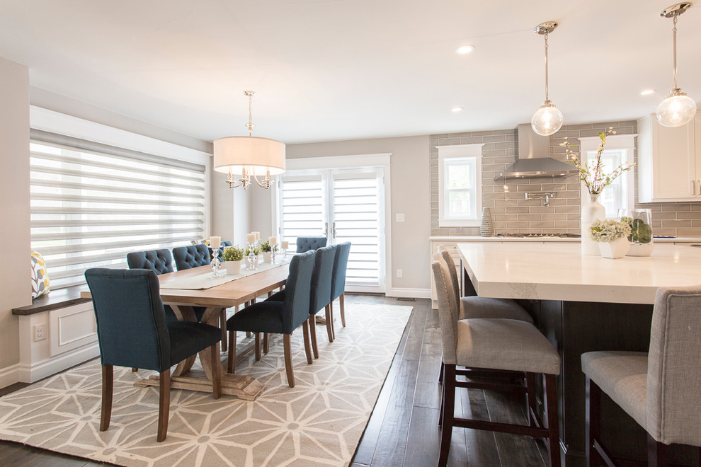 Example of a large transitional l-shaped medium tone wood floor and brown floor eat-in kitchen design in Denver with a single-bowl sink, recessed-panel cabinets, white cabinets, quartz countertops, gray backsplash, ceramic backsplash, stainless steel appliances and two islands