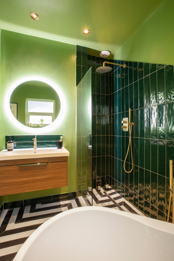 Photo of a mid-sized traditional kids bathroom in London with an open shower, green walls, multi-coloured floor, an open shower, a single vanity and a floating vanity.