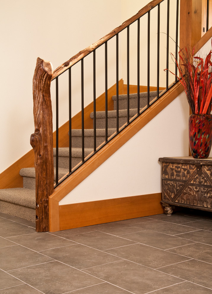 Inspiration for a mid-sized country carpeted l-shaped staircase in Seattle with carpet risers.
