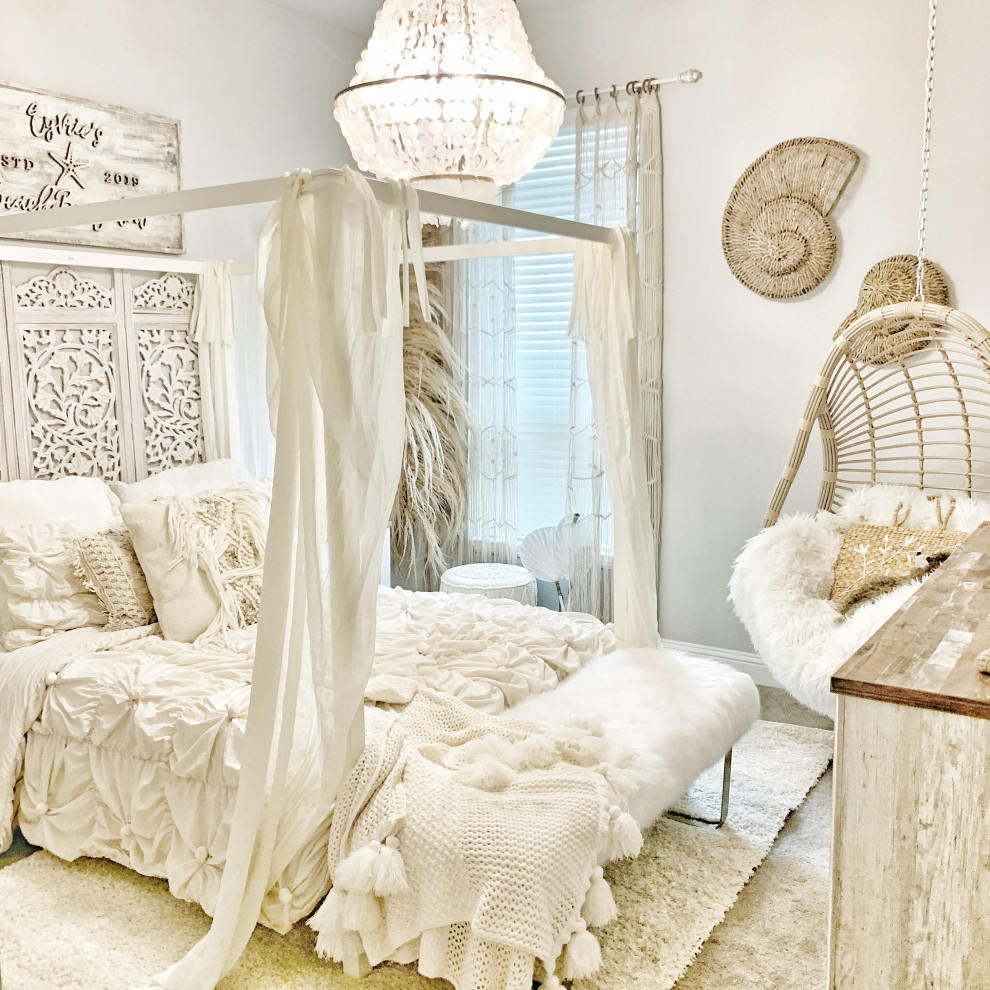 This is an example of a mid-sized beach style guest bedroom with white walls, carpet and beige floor.