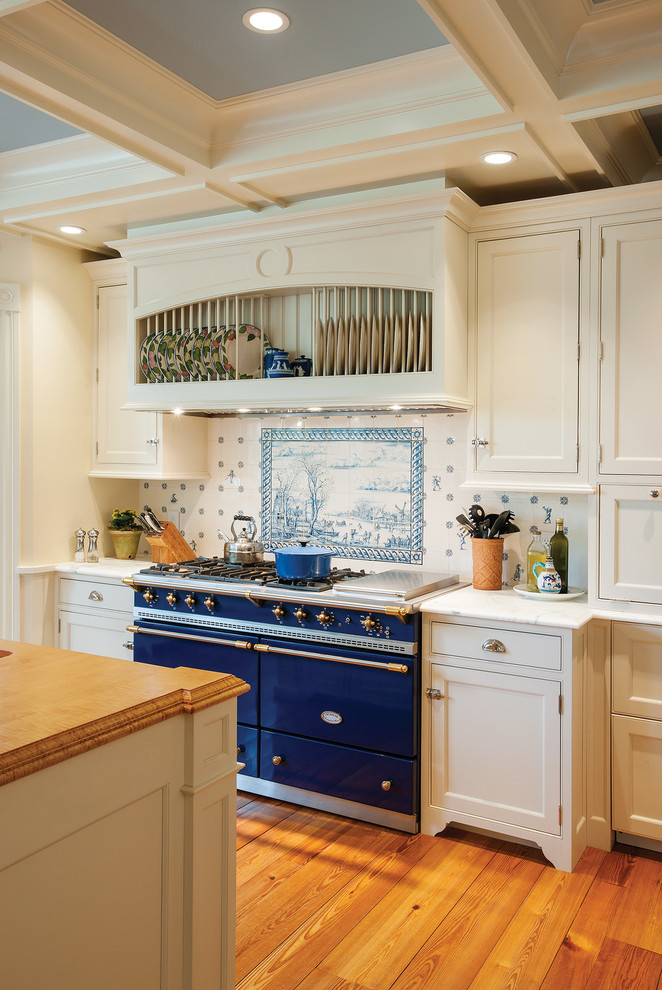 Traditional kitchen in Boston with beaded inset cabinets, white cabinets, multi-coloured splashback, coloured appliances, medium hardwood floors and with island.