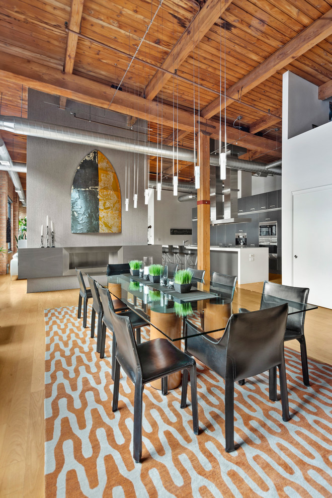 Photo of an industrial open plan dining in Chicago with light hardwood floors and no fireplace.
