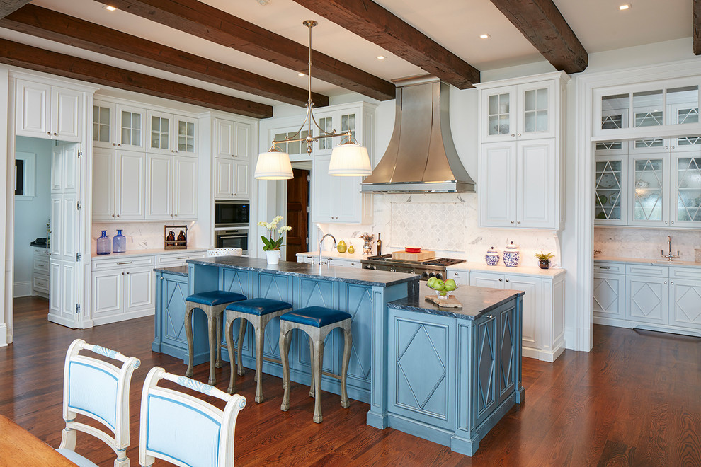 Inspiration for a beach style eat-in kitchen in Miami with raised-panel cabinets, white cabinets, stainless steel appliances, medium hardwood floors and with island.