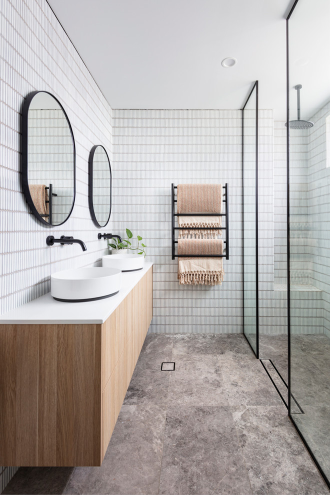 Inspiration for a beach style master bathroom in Sydney with flat-panel cabinets, light wood cabinets, a curbless shower, white tile, mosaic tile, white walls, a vessel sink, grey floor, an open shower and white benchtops.