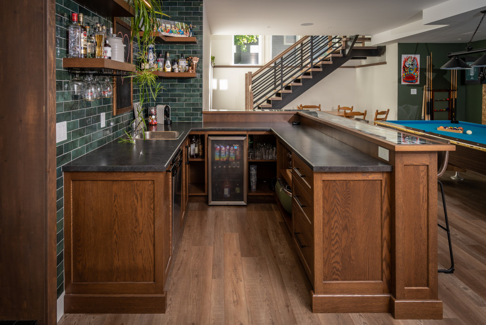 Photo of a small transitional u-shaped wet bar in Other with shaker cabinets, brown cabinets, laminate benchtops, green splashback, ceramic splashback and multi-coloured benchtop.