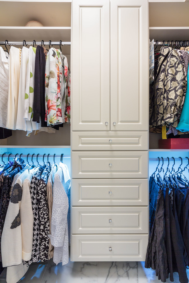 Mid-sized traditional women's walk-in wardrobe in Miami with raised-panel cabinets, white cabinets and marble floors.