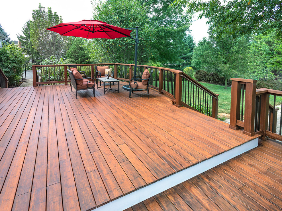 Deck - large transitional backyard deck idea with an awning