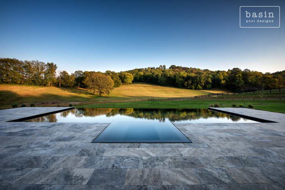 Inspiration for a large transitional backyard stone and custom-shaped infinity hot tub remodel in Nashville