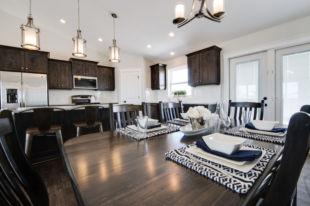 Mid-sized transitional l-shaped open concept kitchen photo with shaker cabinets, dark wood cabinets, laminate countertops, stainless steel appliances and an island