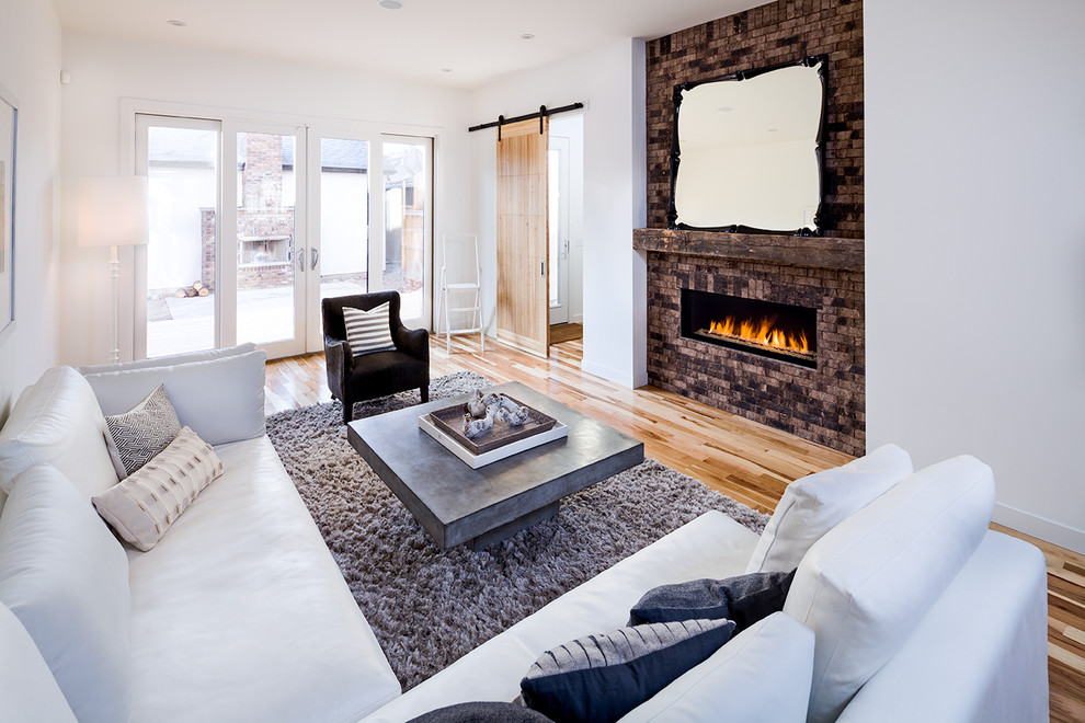 This is an example of a contemporary living room in Calgary with white walls.