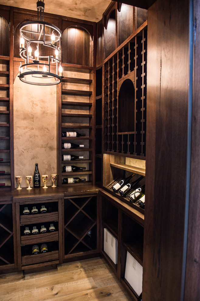 Mid-sized mediterranean wine cellar in Vancouver with storage racks.