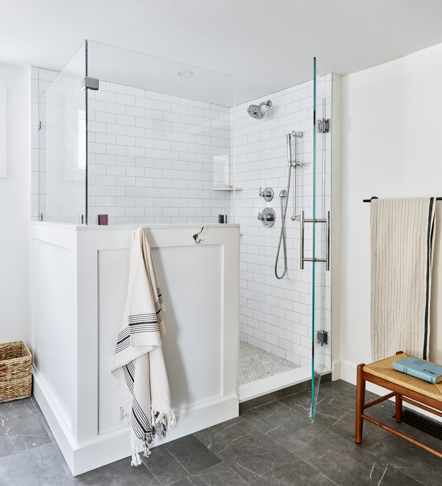 This is an example of a mid-sized transitional master bathroom in Boston with medium wood cabinets, a corner shower, a two-piece toilet, white tile, white walls, porcelain floors, an undermount sink, engineered quartz benchtops, grey floor, a hinged shower door, white benchtops, a single vanity and a freestanding vanity.