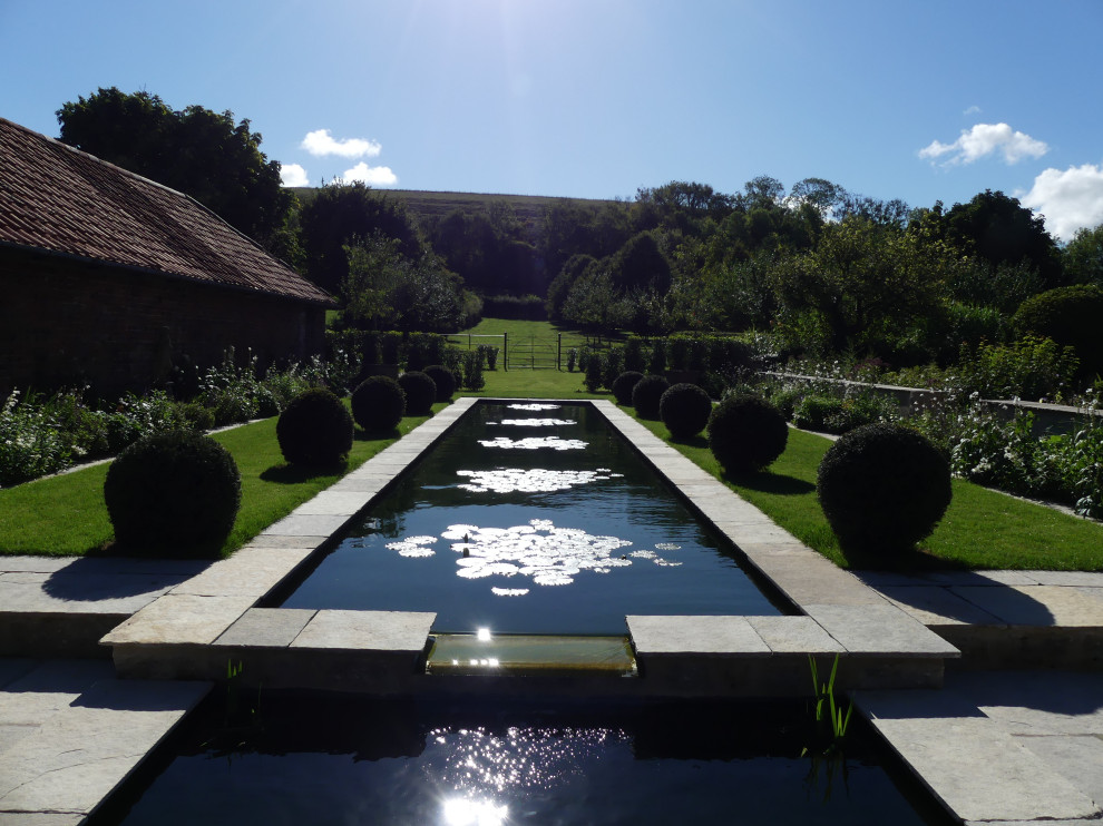 Свежая идея для дизайна: большой солнечный регулярный сад на заднем дворе в современном стиле с водопадом, хорошей освещенностью и покрытием из каменной брусчатки - отличное фото интерьера