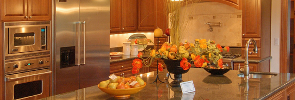 Eat-in kitchen - u-shaped eat-in kitchen idea in Ottawa with a drop-in sink, raised-panel cabinets, light wood cabinets, granite countertops, beige backsplash, stone tile backsplash, stainless steel appliances and an island