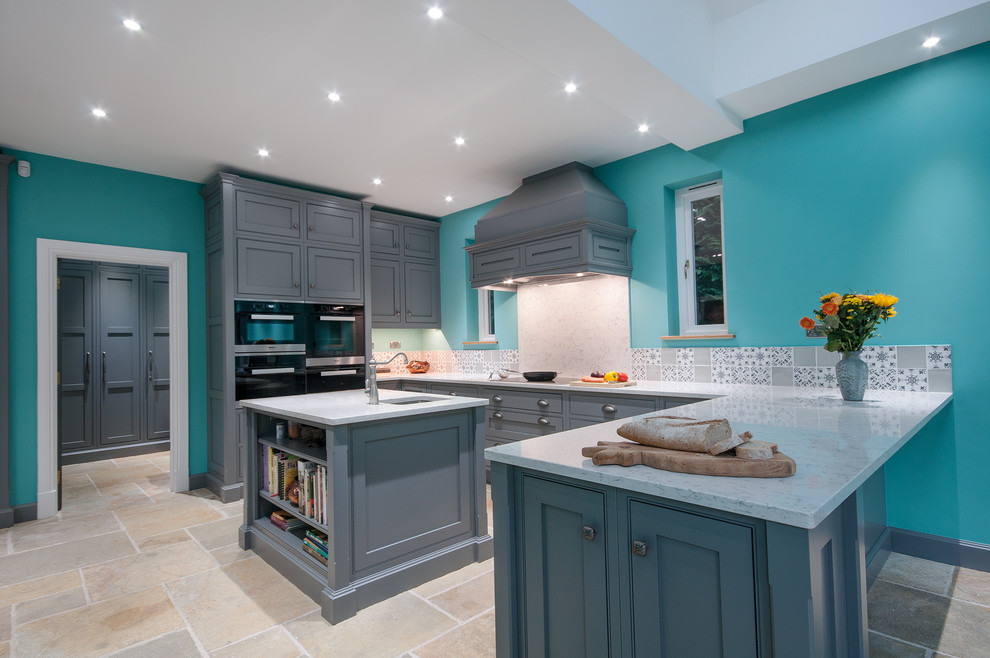 Design ideas for an expansive traditional u-shaped open plan kitchen in Surrey with an integrated sink, shaker cabinets, grey cabinets, quartzite benchtops, grey splashback, cement tile splashback, stainless steel appliances, travertine floors and multiple islands.