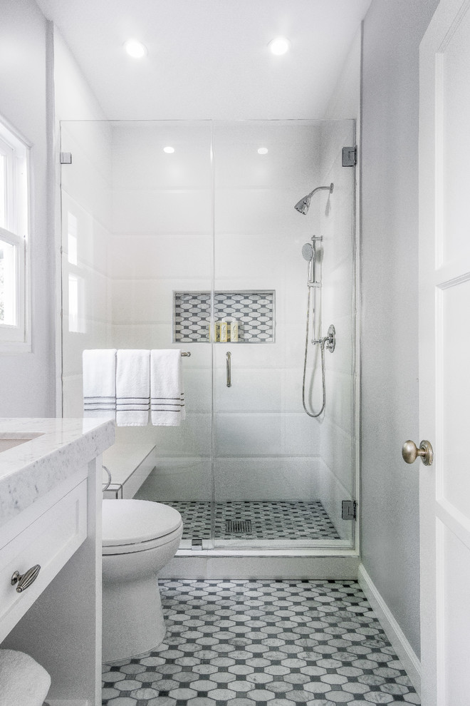 Photo of a large traditional 3/4 bathroom in Los Angeles with grey cabinets, an alcove shower, white tile, porcelain tile, grey walls, marble floors, an undermount sink, granite benchtops, grey floor, a hinged shower door, grey benchtops and a built-in vanity.
