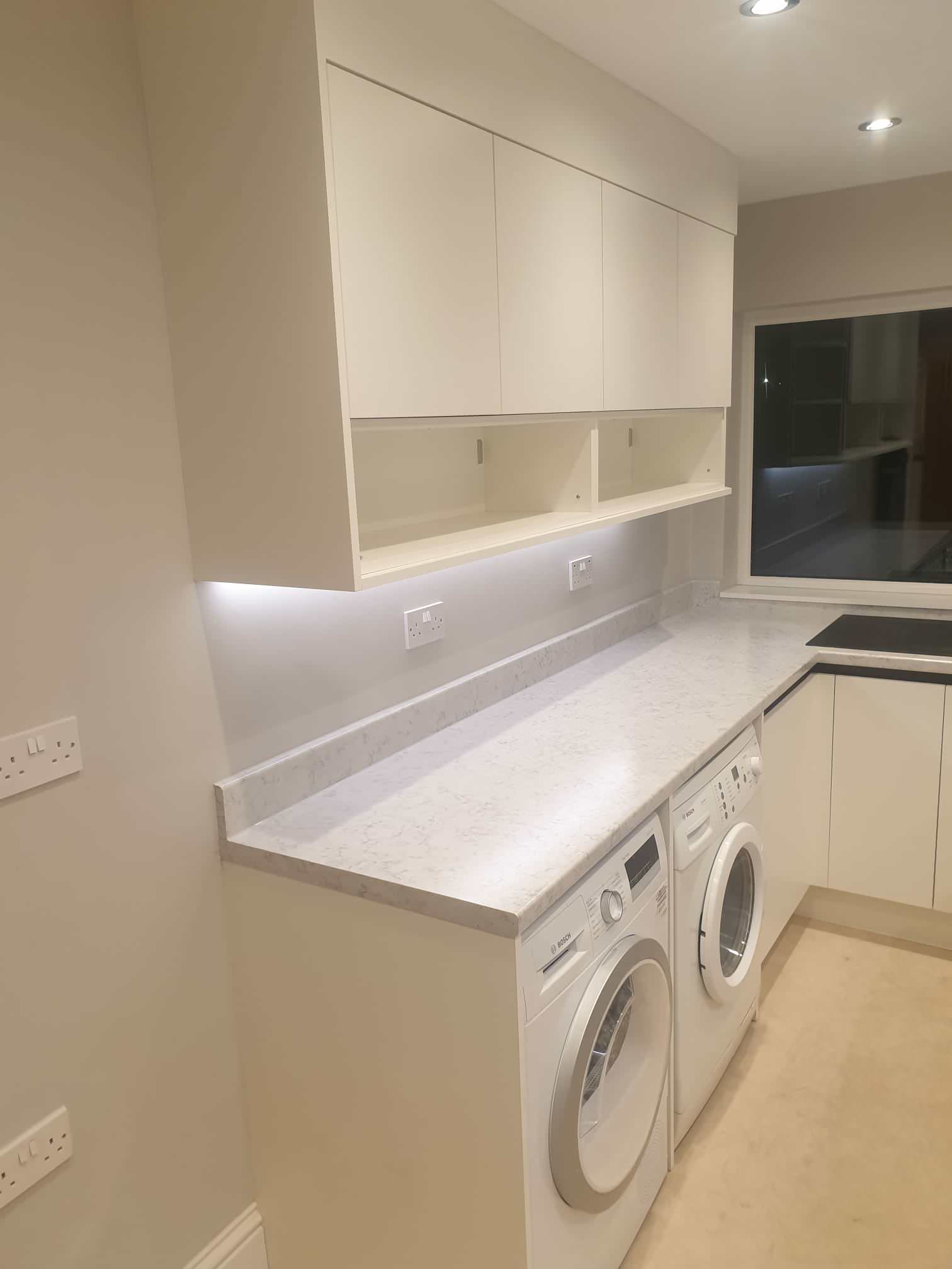 Kitchen - small contemporary kitchen idea in West Midlands with laminate countertops and white countertops