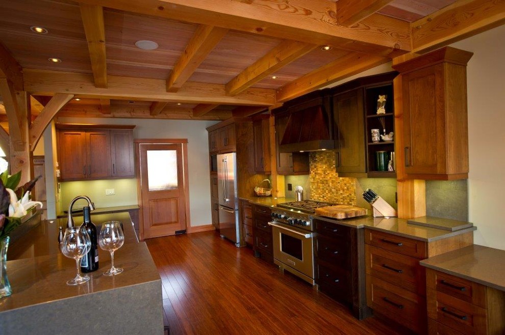 Example of a mid-sized transitional galley medium tone wood floor open concept kitchen design in Vancouver with an undermount sink, shaker cabinets, medium tone wood cabinets, quartz countertops, green backsplash, porcelain backsplash, stainless steel appliances and an island
