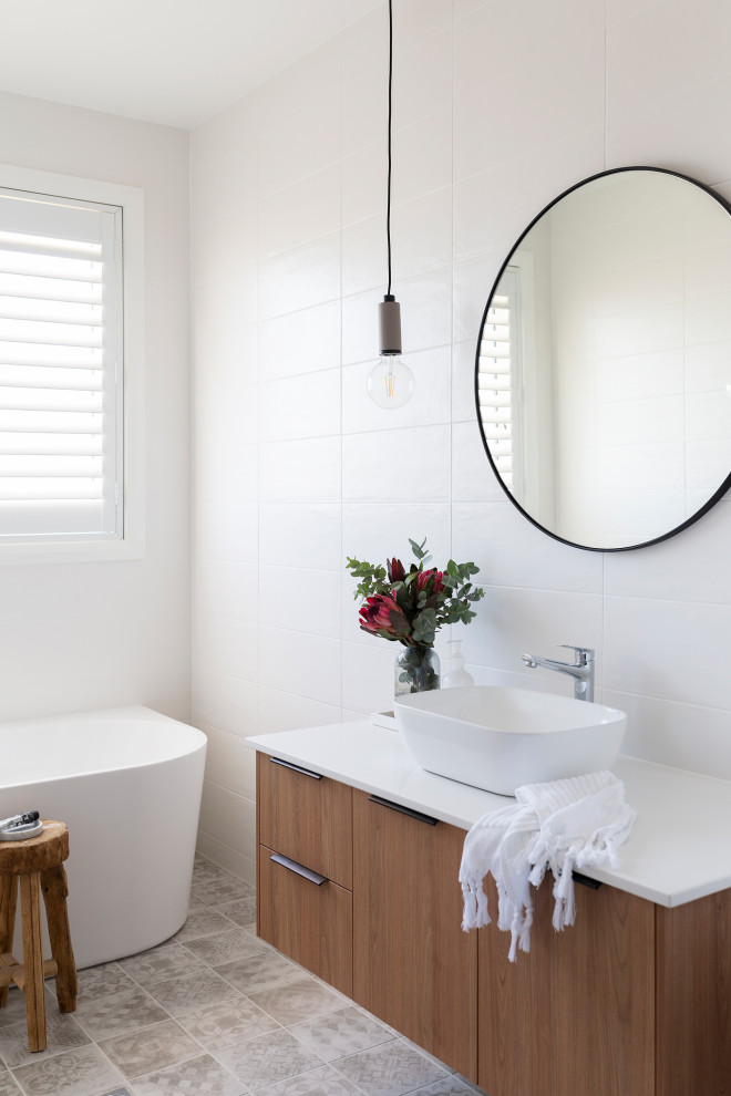 Photo of a mid-sized contemporary 3/4 bathroom in Canberra - Queanbeyan with a freestanding tub, white tile, porcelain tile, engineered quartz benchtops, white benchtops and a single vanity.