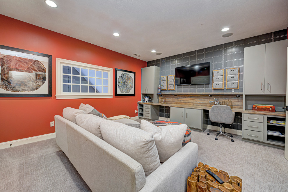 This is an example of a medium sized contemporary home studio in Indianapolis with multi-coloured walls, carpet, a built-in desk and grey floors.