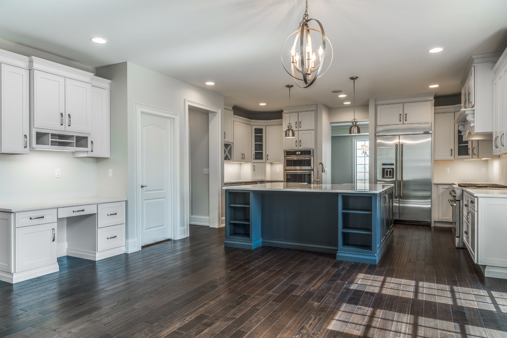 Inspiration for a large transitional u-shaped dark wood floor and brown floor kitchen remodel with a farmhouse sink, shaker cabinets, blue cabinets, quartzite countertops, stainless steel appliances and an island