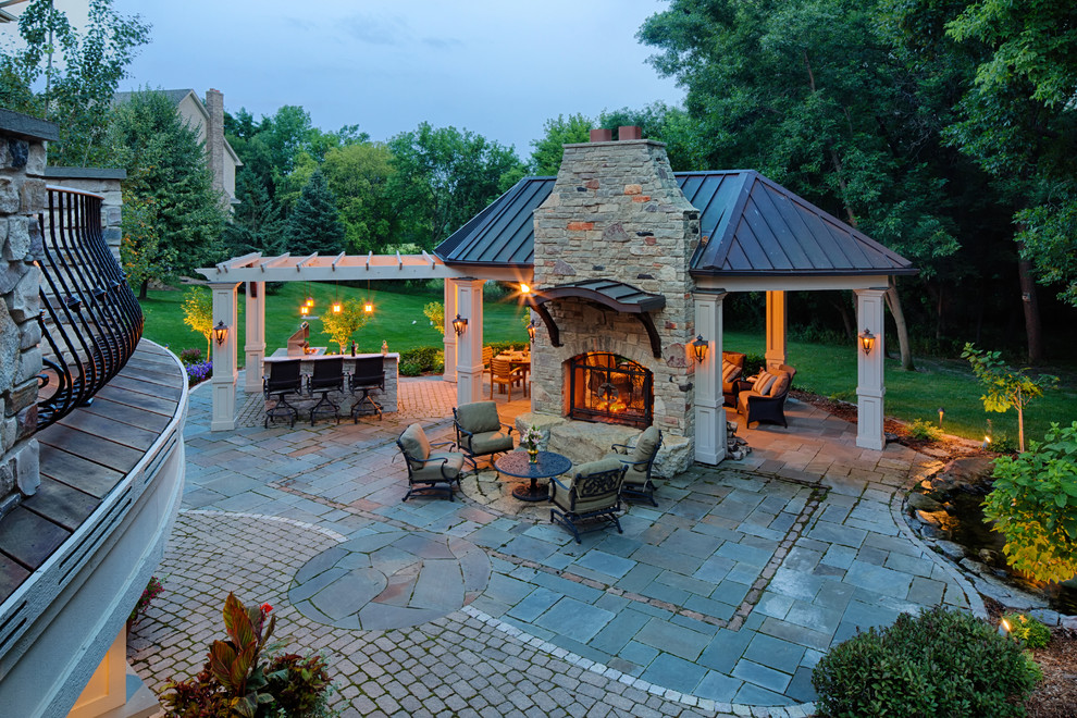 Traditional patio in Minneapolis with a fire feature and a gazebo/cabana.