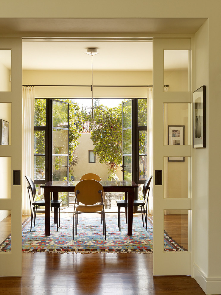 Large contemporary dining room in San Francisco with beige walls and dark hardwood floors.