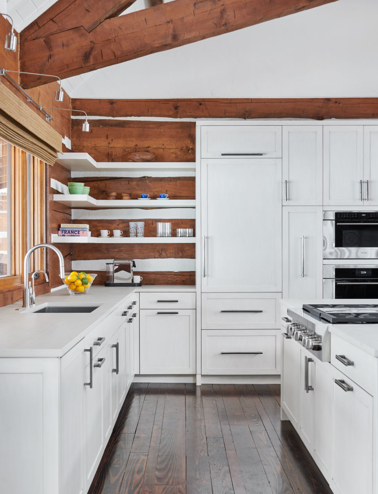 Example of a mountain style open concept kitchen design in Denver with stainless steel appliances