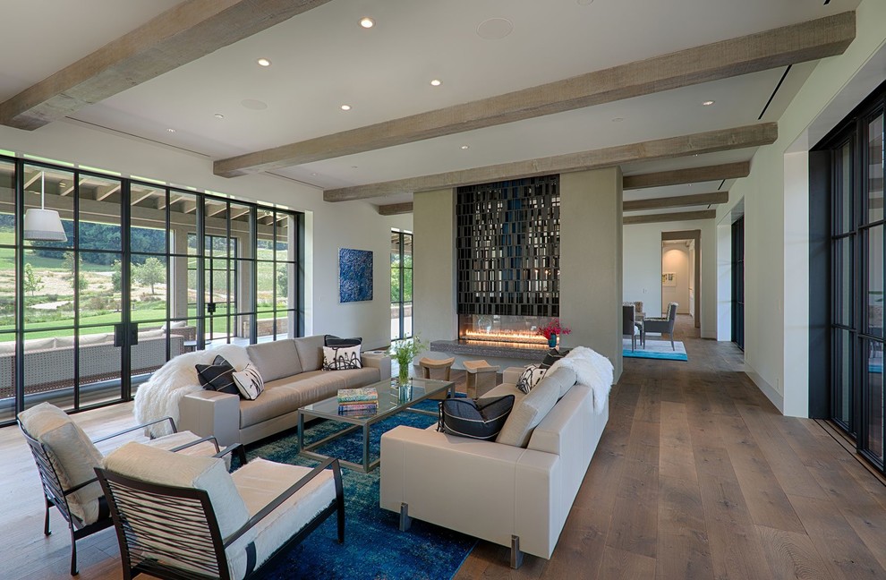 Photo of a contemporary formal open concept living room in Los Angeles with white walls, light hardwood floors, a ribbon fireplace and beige floor.