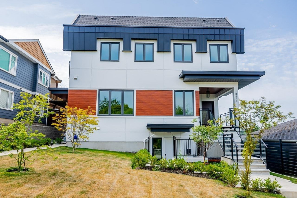 Inspiration for a mid-sized transitional multicolored three-story mixed siding duplex exterior remodel in Vancouver with a shingle roof and a black roof